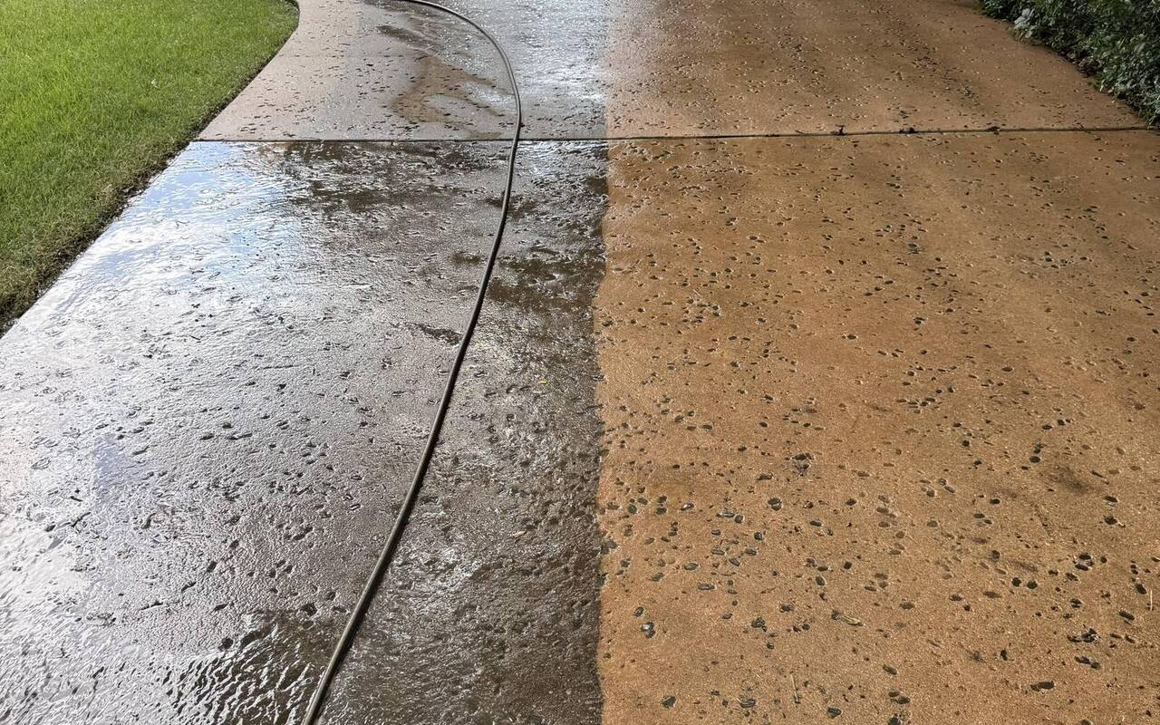 Before and after pressure washing of a concrete walkway